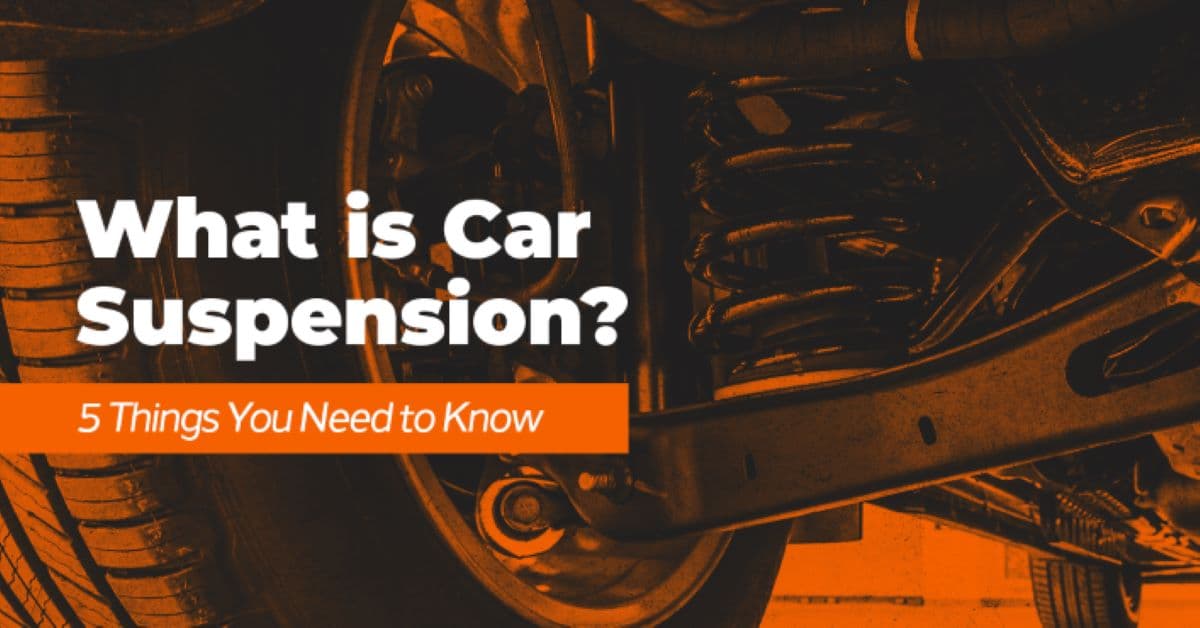 The article title over a suspension spring beside a wheel, with an orange overlay.